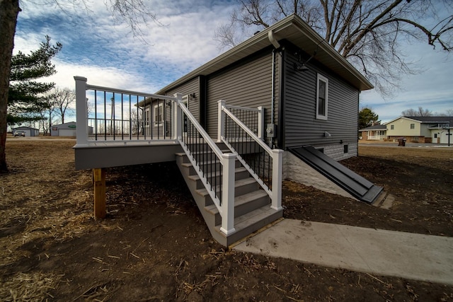 view of property exterior featuring a wooden deck