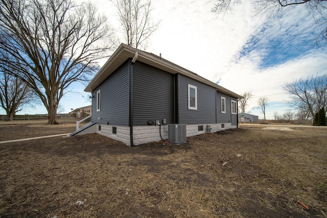 view of side of home with central AC unit