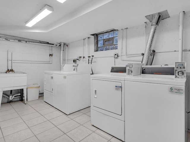 laundry room featuring washer and dryer and light tile patterned flooring