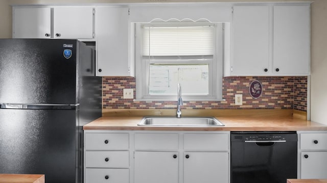 kitchen with white cabinetry, sink, decorative backsplash, and black appliances