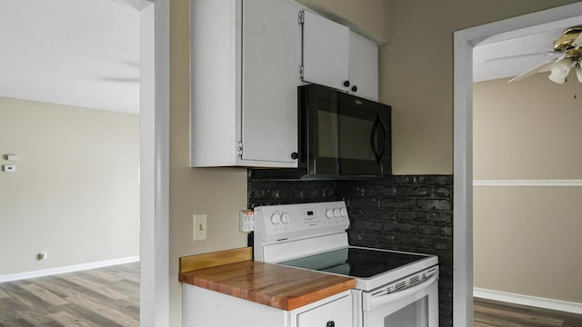 kitchen with white cabinetry, ceiling fan, wood-type flooring, and electric range