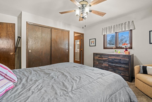 carpeted bedroom with ceiling fan and a closet