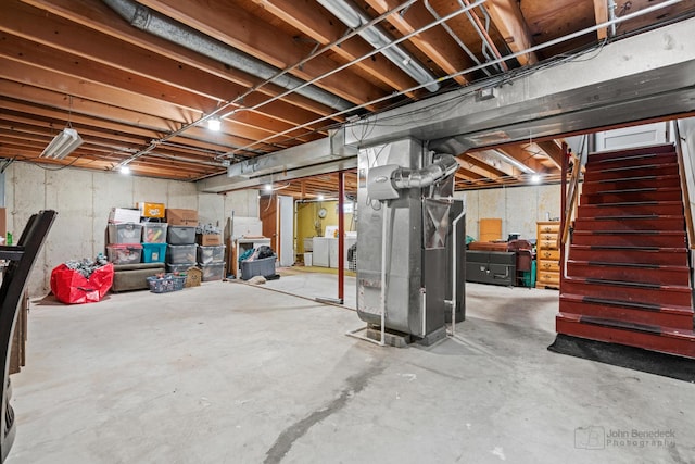 basement with heating unit and washer / dryer