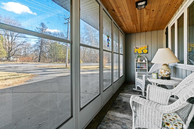 sunroom with a healthy amount of sunlight and wooden ceiling