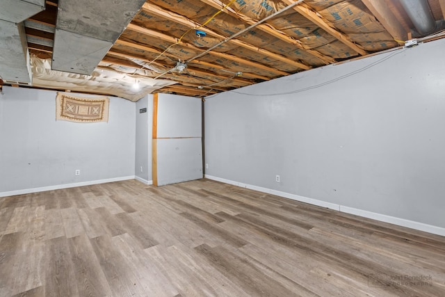 basement with hardwood / wood-style flooring