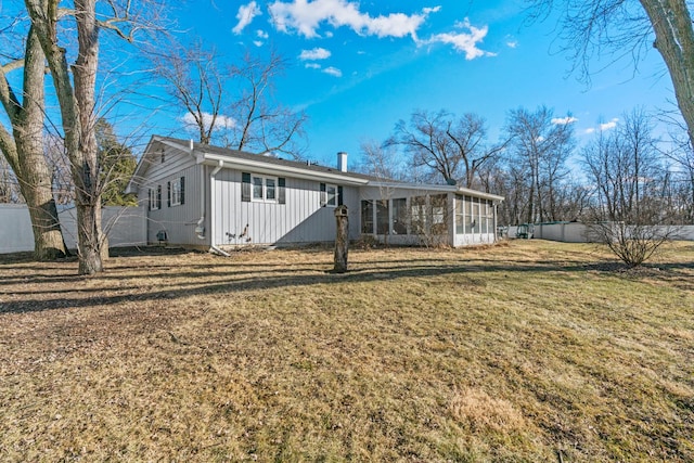 view of front of property featuring a sunroom and a front yard