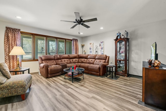 living room featuring ceiling fan and light hardwood / wood-style flooring