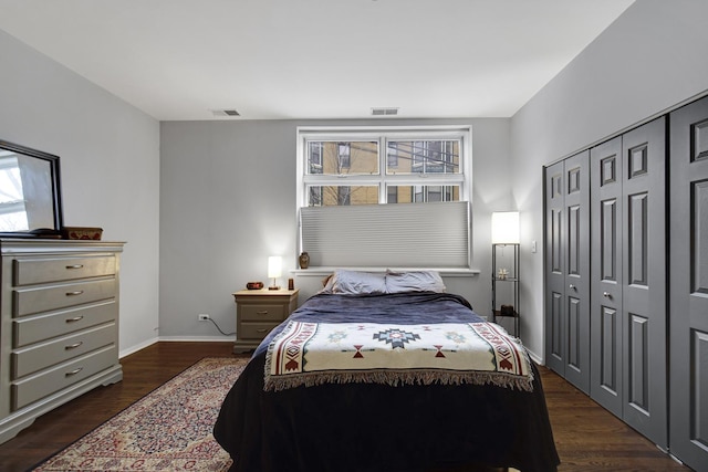 bedroom featuring dark hardwood / wood-style flooring and a closet