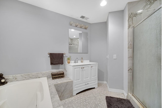 bathroom with shower with separate bathtub, vanity, and tile patterned floors