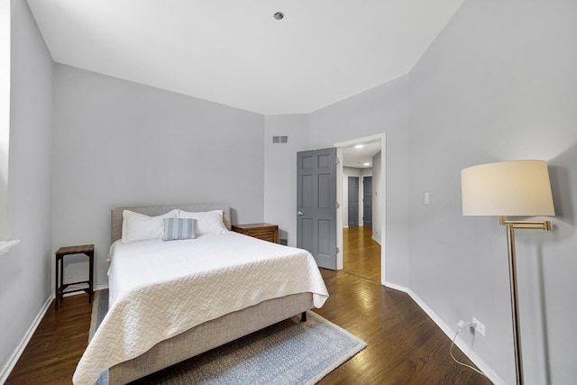 bedroom with dark hardwood / wood-style flooring