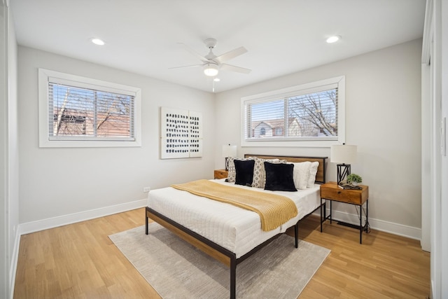 bedroom with light hardwood / wood-style floors and ceiling fan