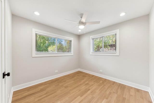 empty room with ceiling fan and light hardwood / wood-style floors