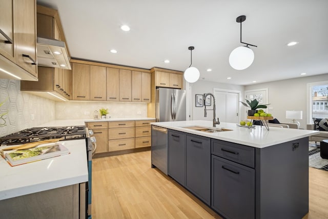 kitchen with sink, gray cabinets, appliances with stainless steel finishes, a center island with sink, and decorative light fixtures