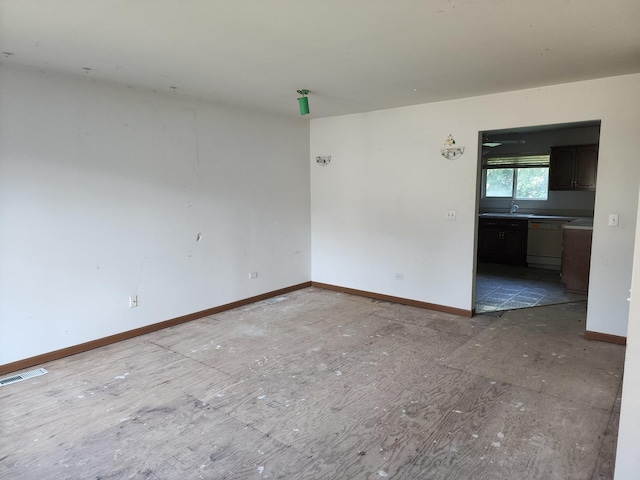 unfurnished room featuring sink