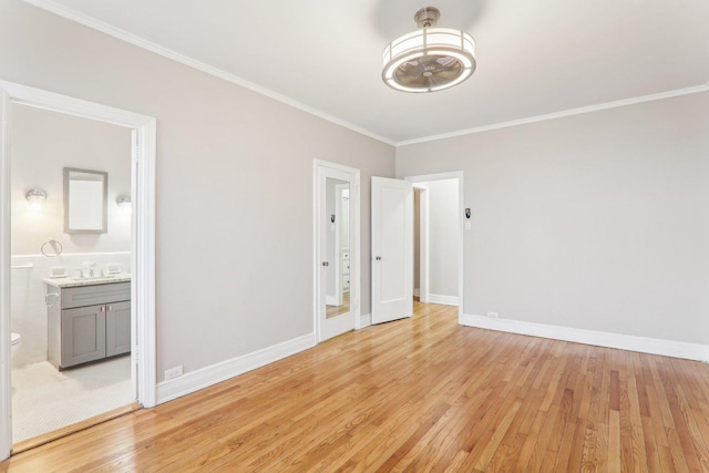 interior space featuring crown molding, sink, and light hardwood / wood-style floors