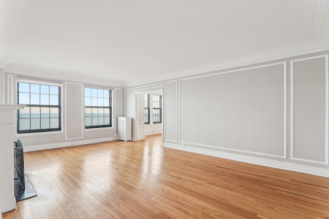 unfurnished living room with radiator and light wood-type flooring