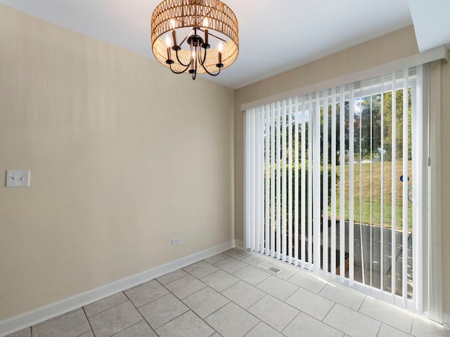 unfurnished room with light tile patterned floors and an inviting chandelier