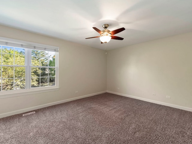 empty room featuring ceiling fan and carpet flooring