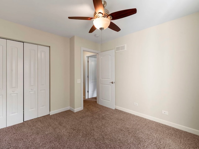 unfurnished bedroom with carpet, ceiling fan, and a closet