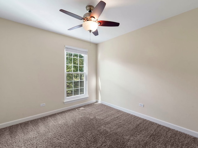 spare room with carpet floors and ceiling fan