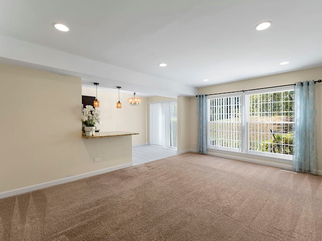 unfurnished living room featuring light carpet