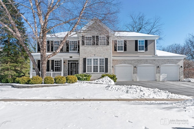 view of front facade featuring driveway and brick siding