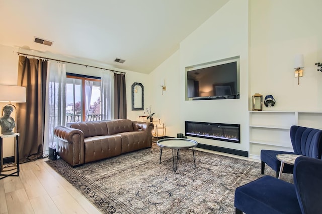 living room with vaulted ceiling and hardwood / wood-style floors