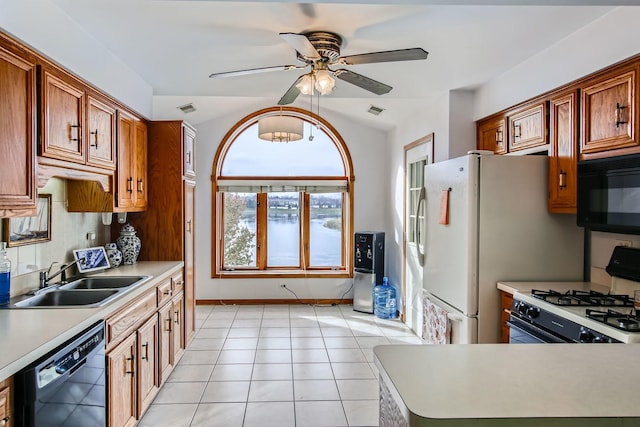 kitchen featuring sink, backsplash, light tile patterned floors, ceiling fan, and black appliances