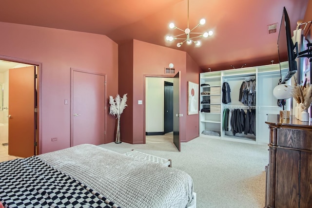 carpeted bedroom featuring connected bathroom, vaulted ceiling, a closet, and a notable chandelier