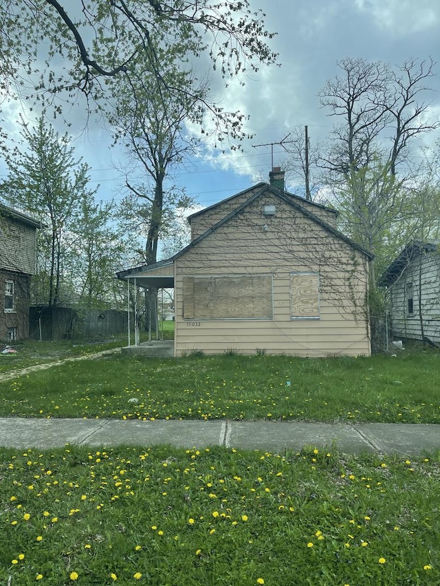 view of side of property with a yard