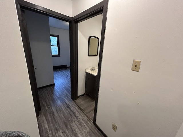 corridor with dark hardwood / wood-style flooring