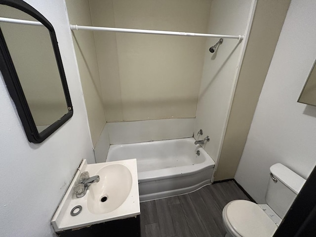 full bathroom featuring wood-type flooring, toilet, shower / bathing tub combination, and vanity