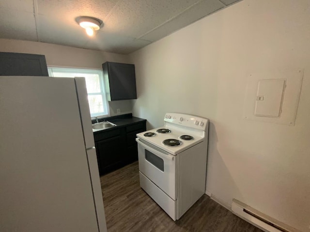 kitchen featuring sink, white appliances, dark wood-type flooring, baseboard heating, and a textured ceiling