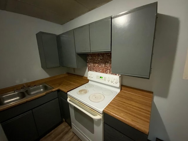 kitchen featuring sink and white electric range oven