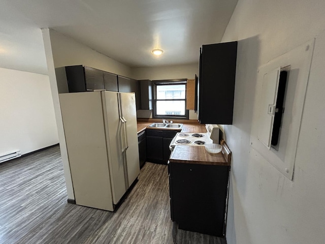 kitchen featuring white appliances, wood-type flooring, sink, and wooden counters