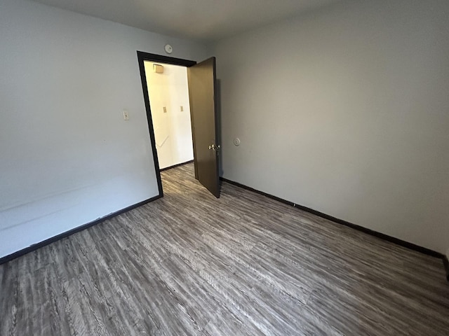 empty room featuring dark wood-type flooring