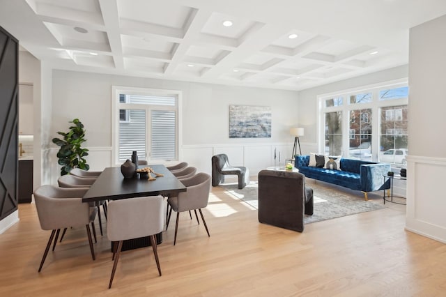 interior space featuring coffered ceiling, beam ceiling, and light hardwood / wood-style flooring