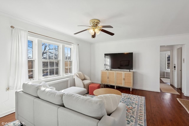 living room with crown molding, ceiling fan, and dark hardwood / wood-style flooring