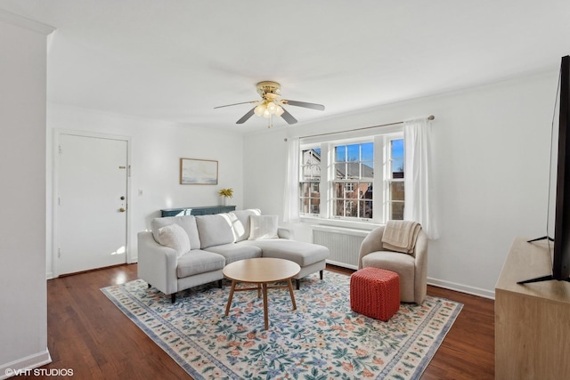 living room with dark wood-type flooring, radiator heating unit, and ceiling fan