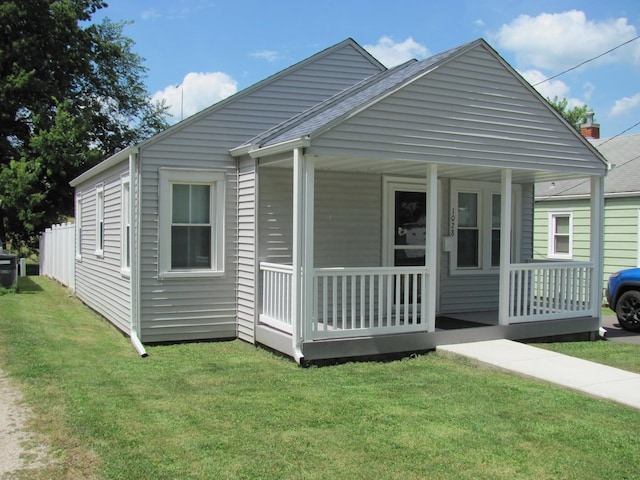 view of front of house with a front yard and covered porch