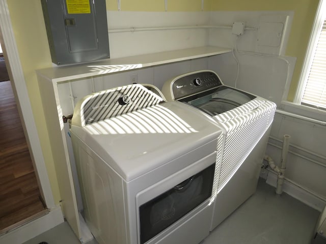 clothes washing area with independent washer and dryer and electric panel