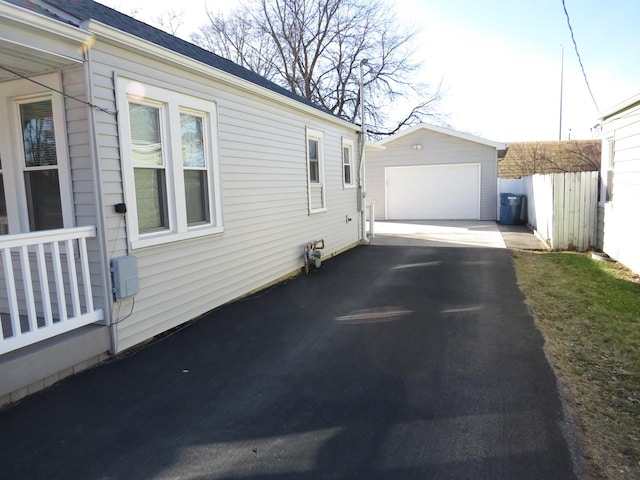 view of property exterior featuring an outbuilding and a garage