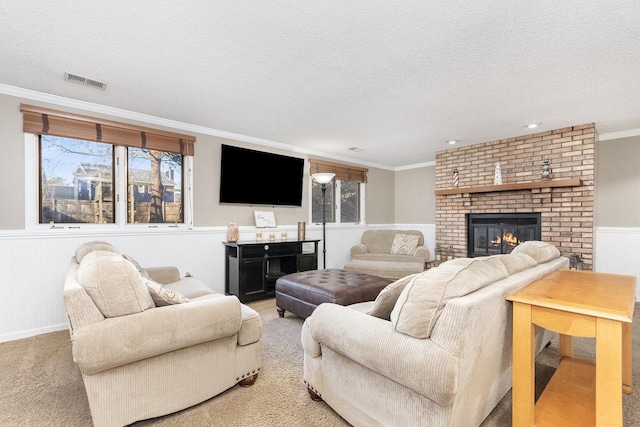 living room featuring light colored carpet, ornamental molding, and a textured ceiling