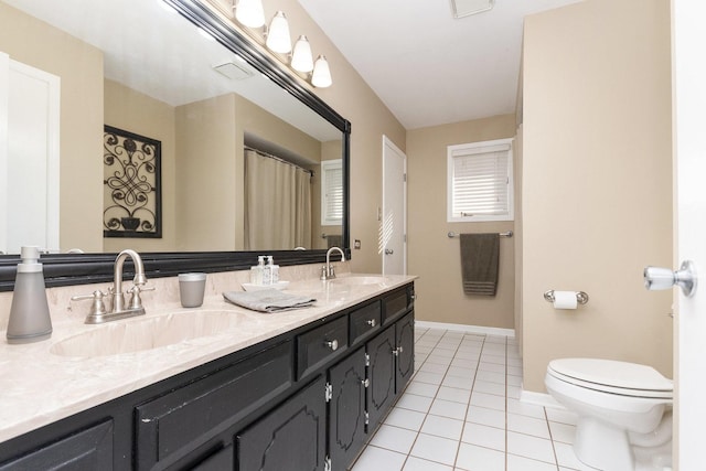 bathroom featuring vanity, toilet, and tile patterned flooring