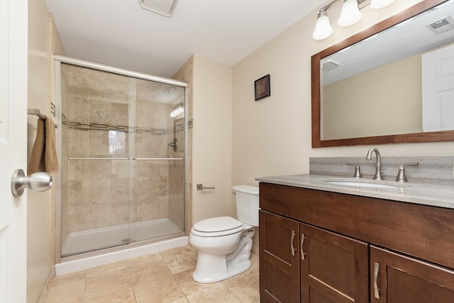 bathroom with vanity, toilet, and a shower with shower door