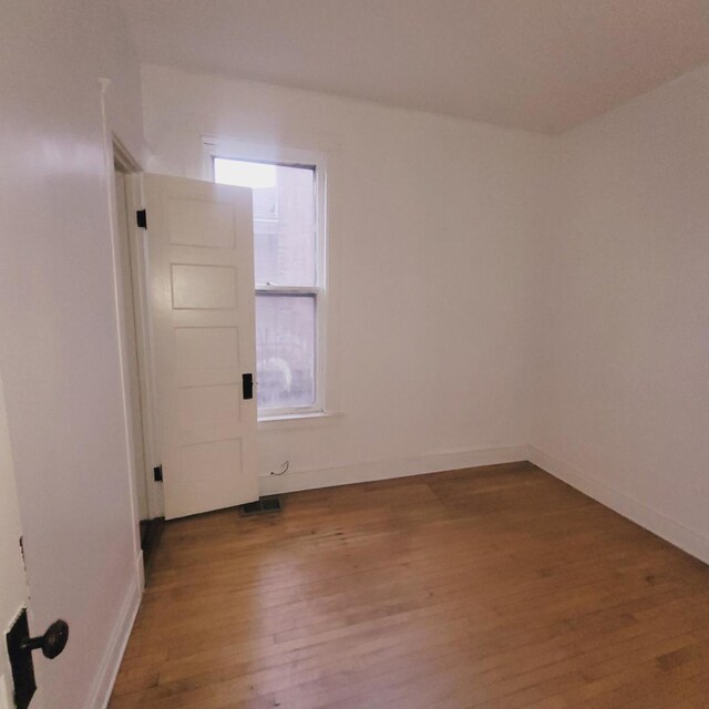 unfurnished room featuring hardwood / wood-style floors