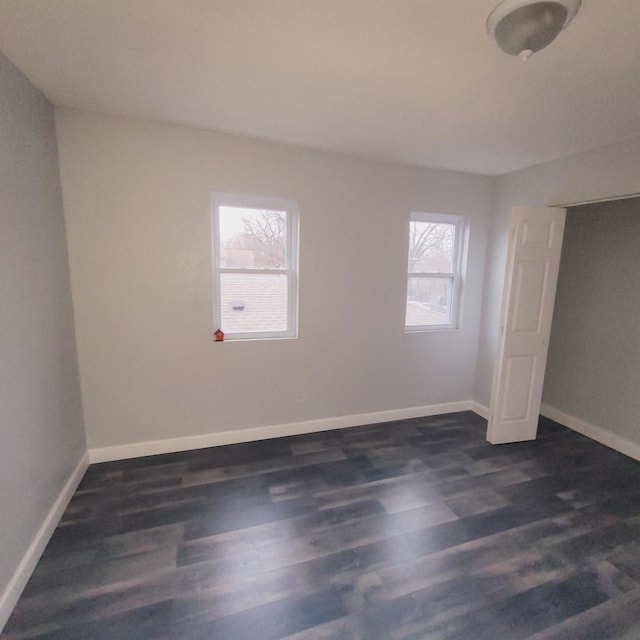 empty room with dark wood-type flooring