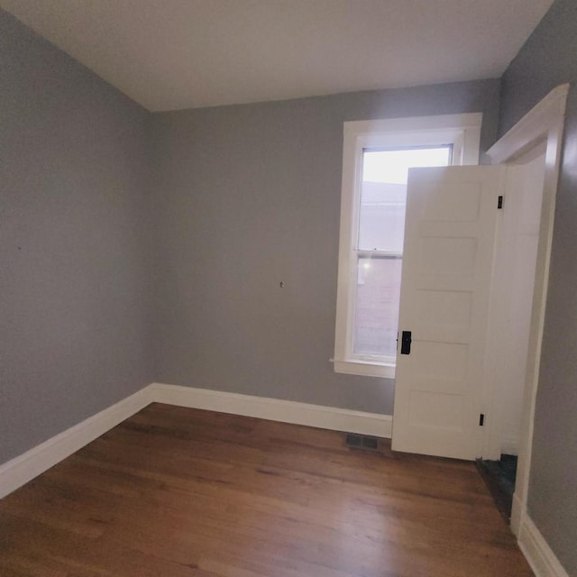 spare room featuring dark hardwood / wood-style flooring