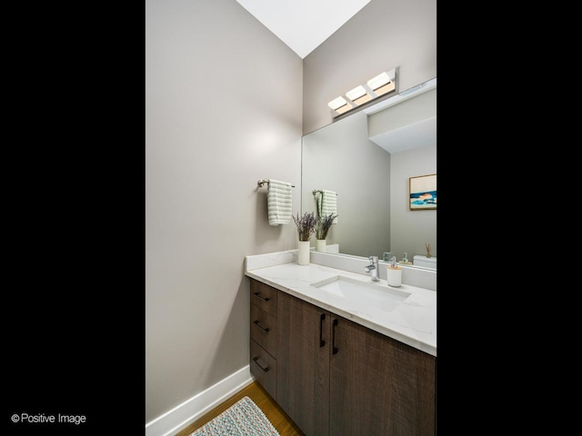 bathroom with vanity and hardwood / wood-style floors