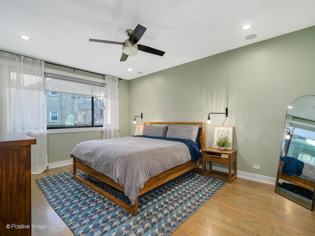 bedroom featuring ceiling fan and light hardwood / wood-style floors